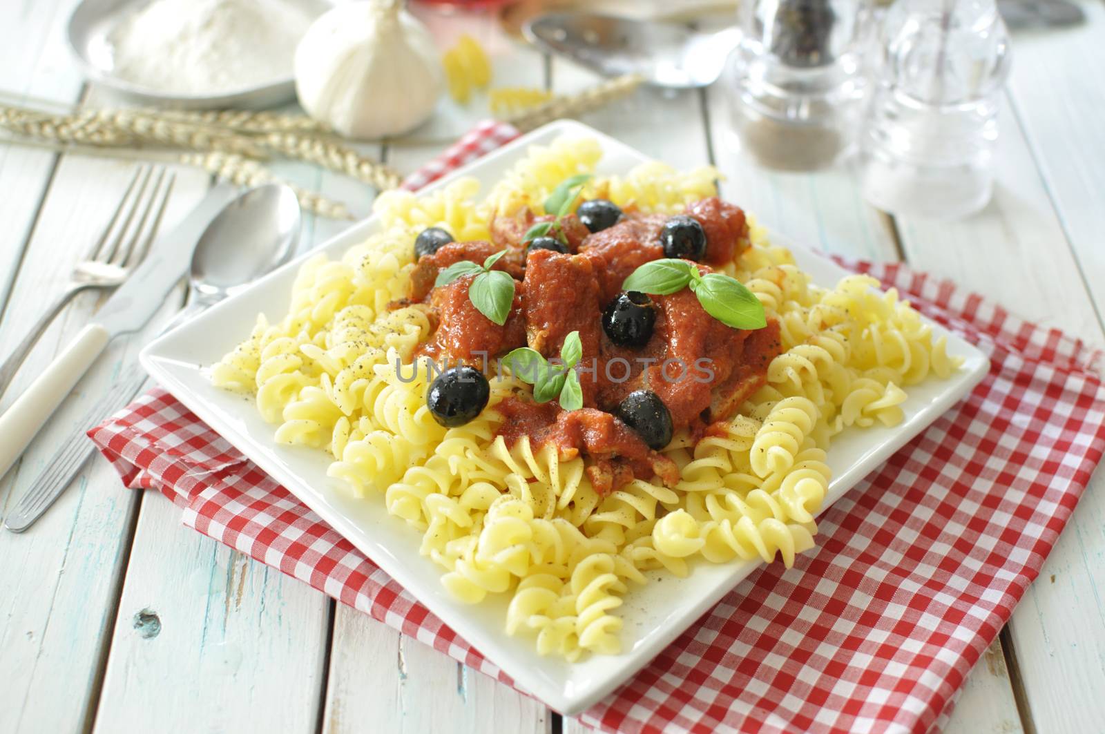 Italian pasta dish with tomato sauce and basil 