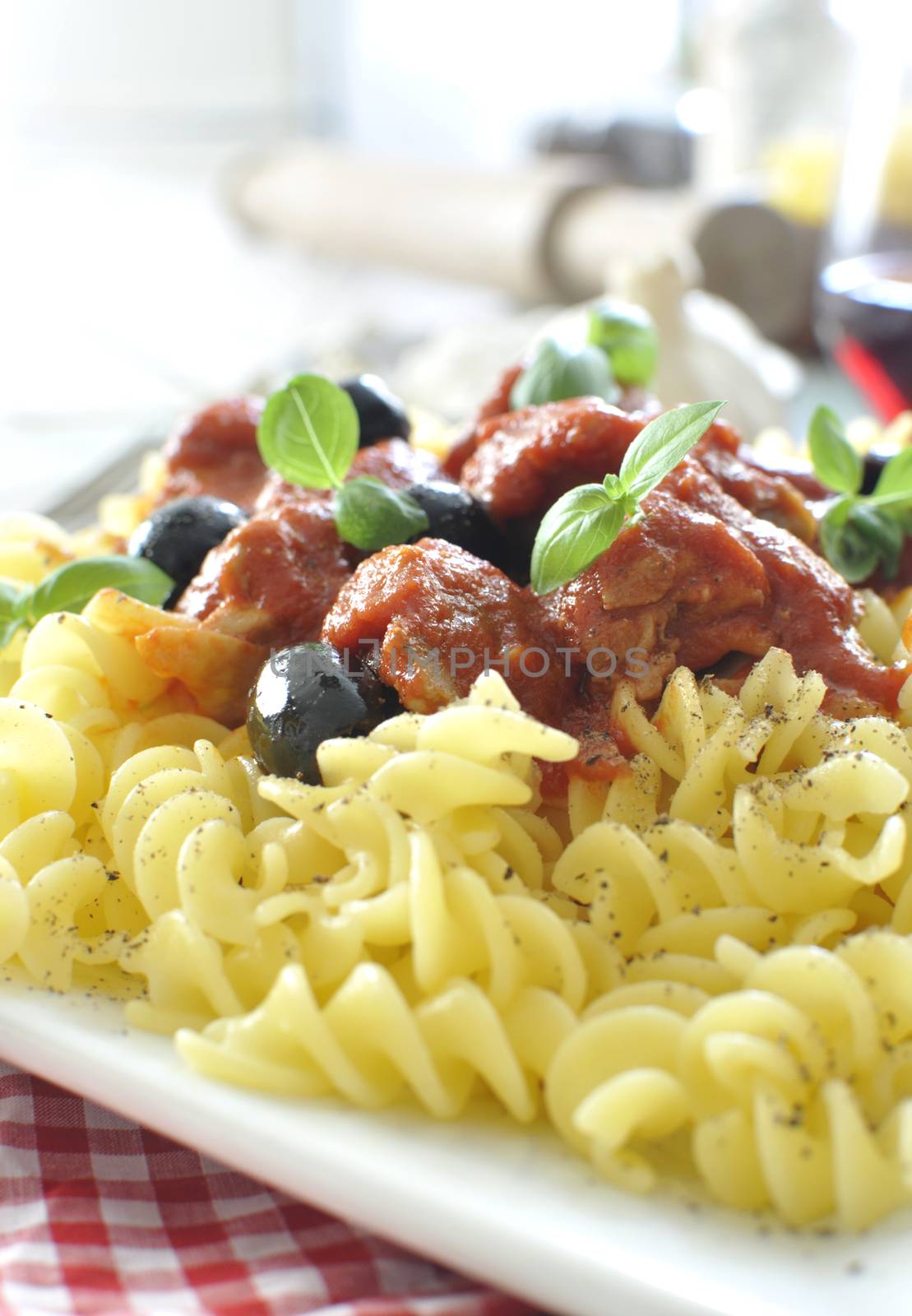 Italian pasta dish with tomato sauce and basil 