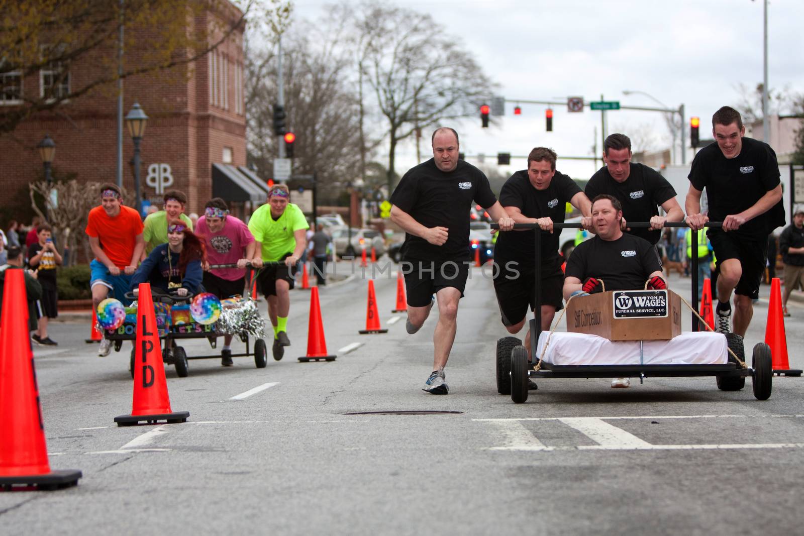 Lawrenceville, GA, USA - March 29, 2014:  Two teams race custom designed beds through downtown Lawrenceville, to benefit a local homeless shelter. 