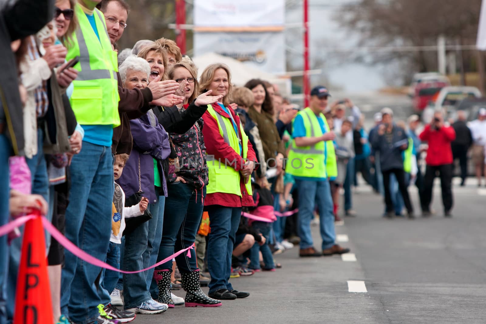 Spectators Cheer Oncoming Participants In Small Town Race by BluIz60