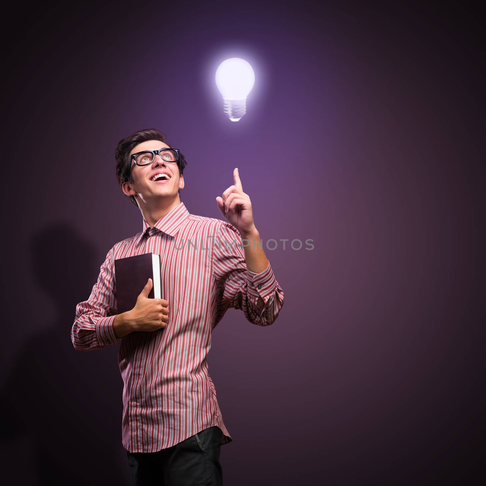 young man holding a book in front of him, raised his hand, the idea