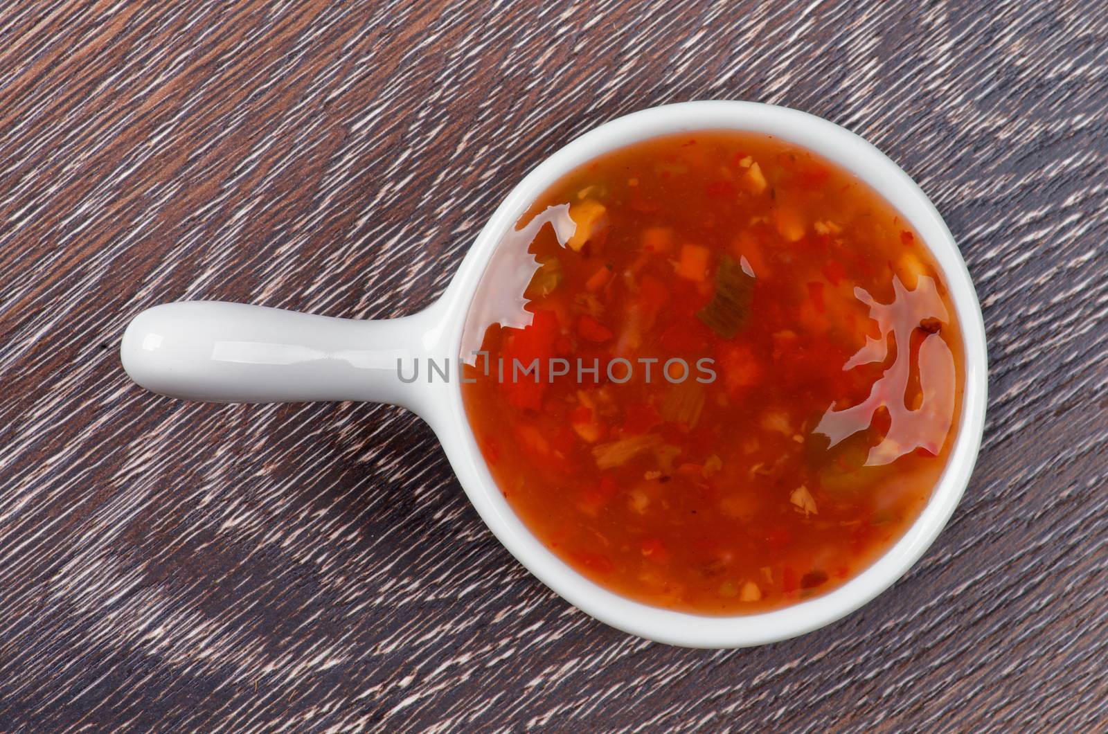 Sweet and Sour Sauce in White Sauce Gravy isolated on Wooden background. Top View