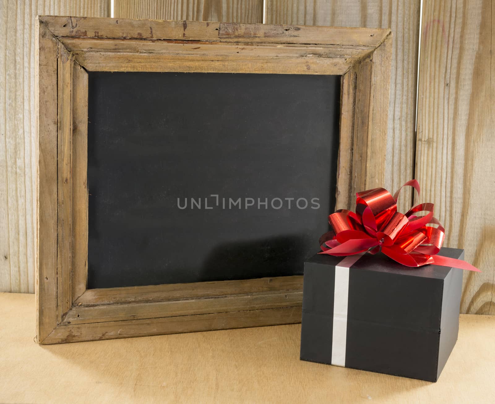 black wooden blackboard with present