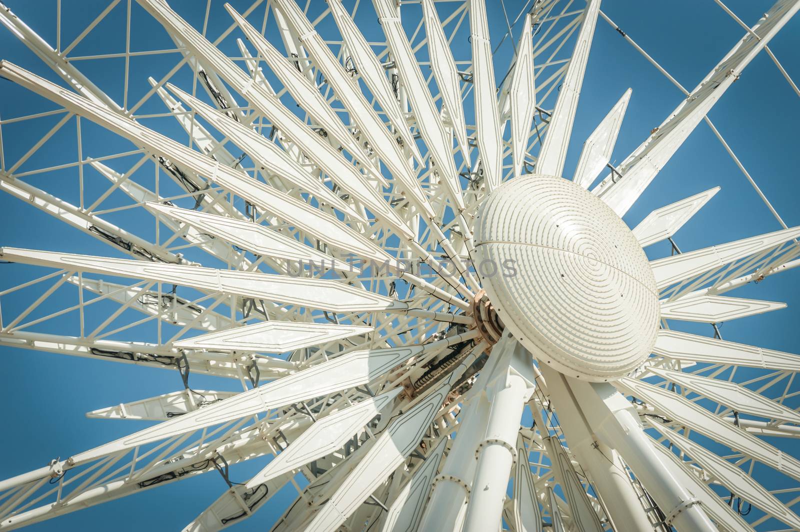 theme park ferris wheel detail against a blue sky