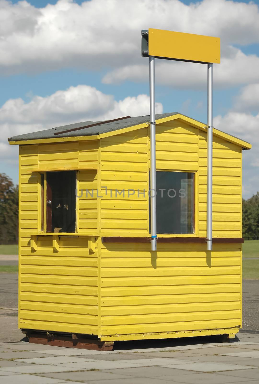 wooden ticket booth with clear sign above