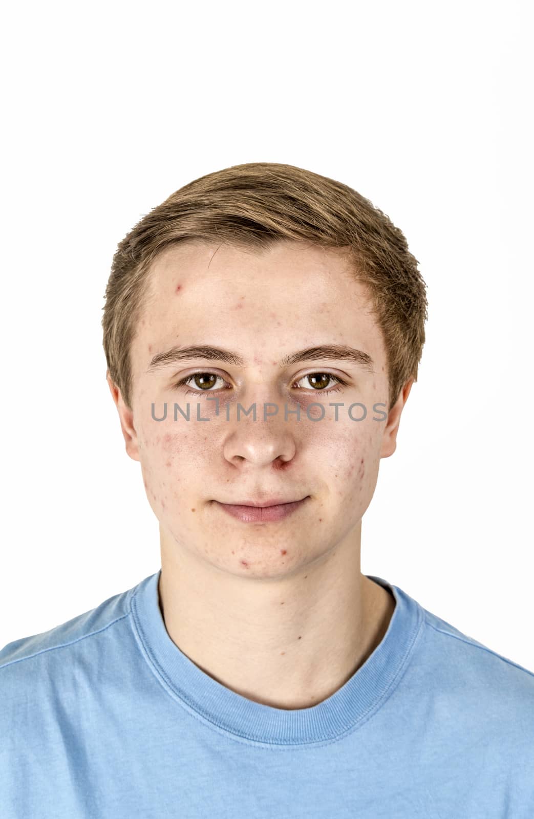 portrait of cool boy with blue shirt posing in studio