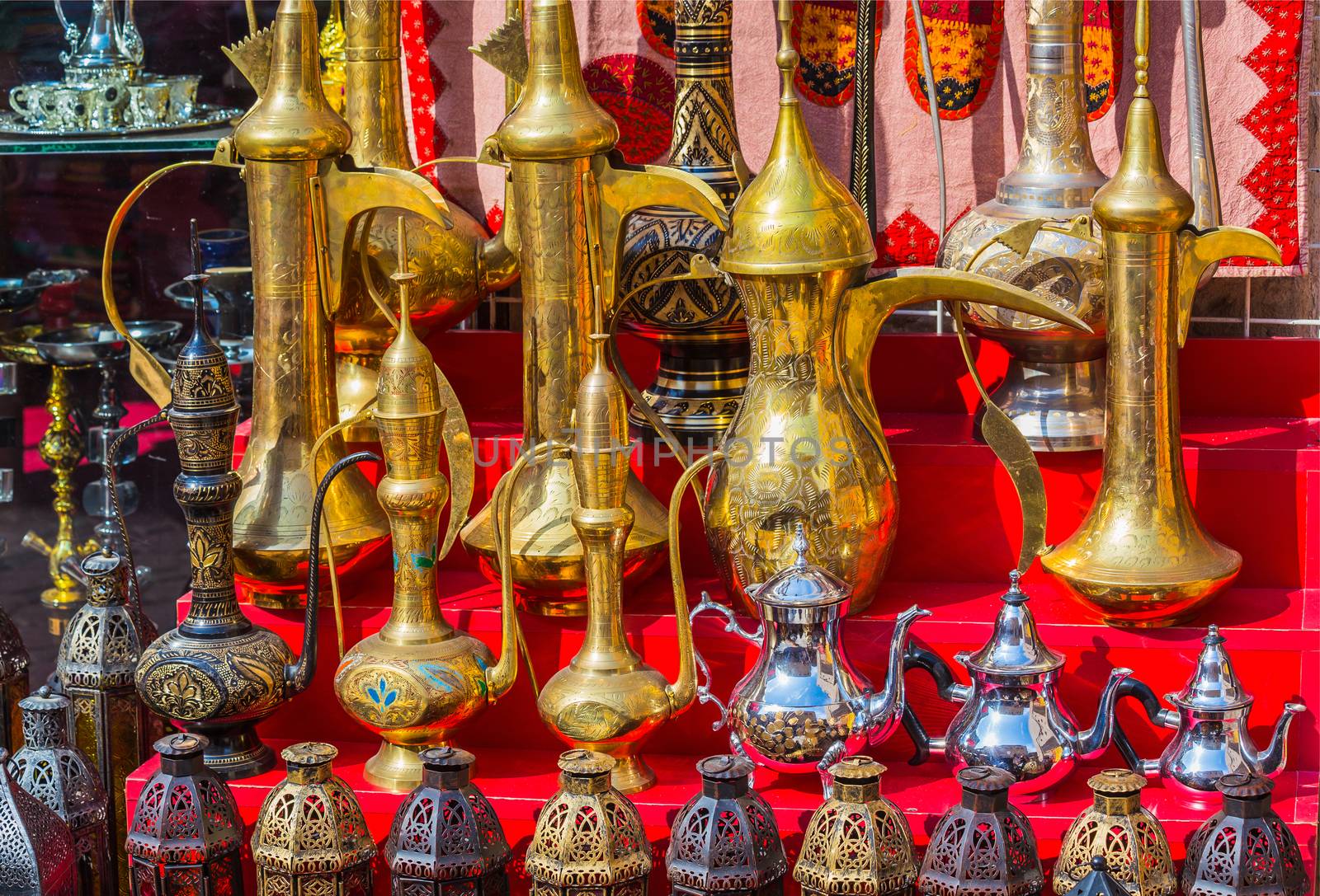 row of shiny traditional coffee pots and lamp by oleg_zhukov