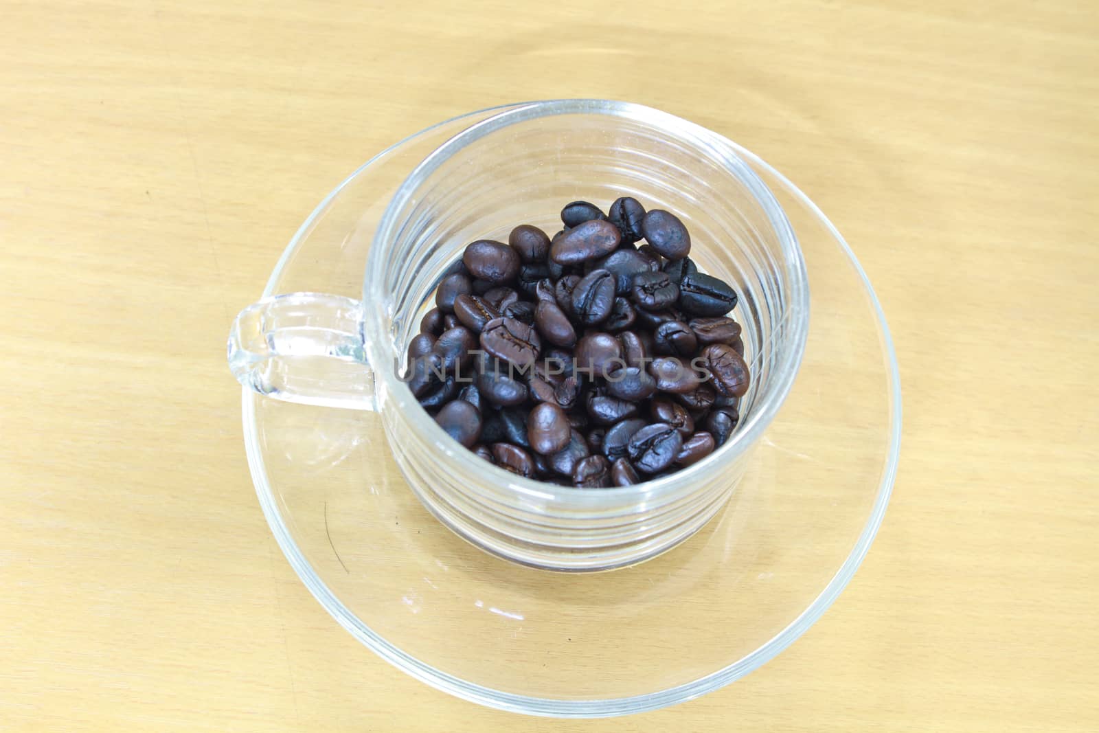 coffee beans in cup on the wood table
