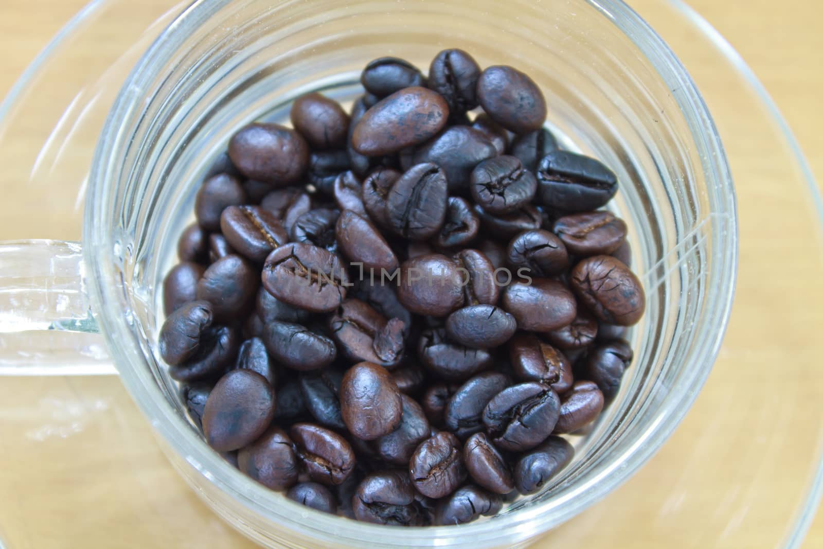coffee beans in cup on the wood table