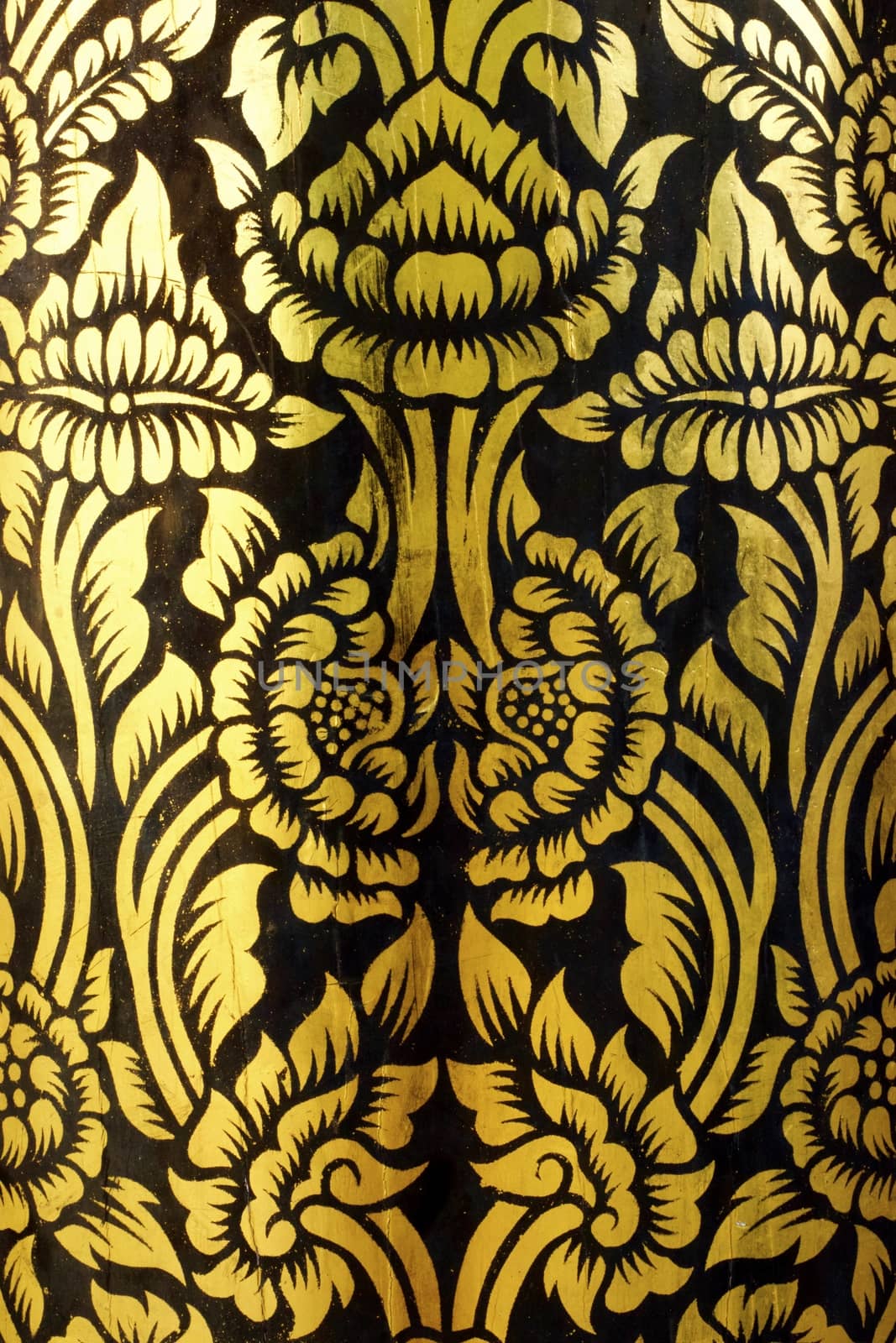 detail of thai pattern that made by covered wood plate with gold leaf for decorated temple door or pillar,shallow focus