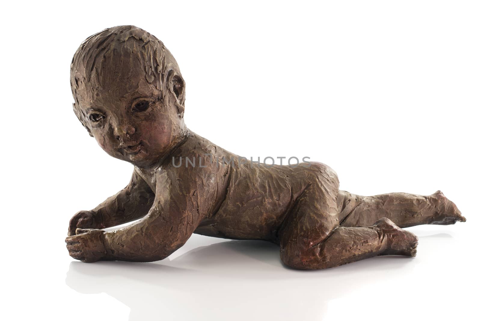 statue of crawlng baby made from clay isolated on white
