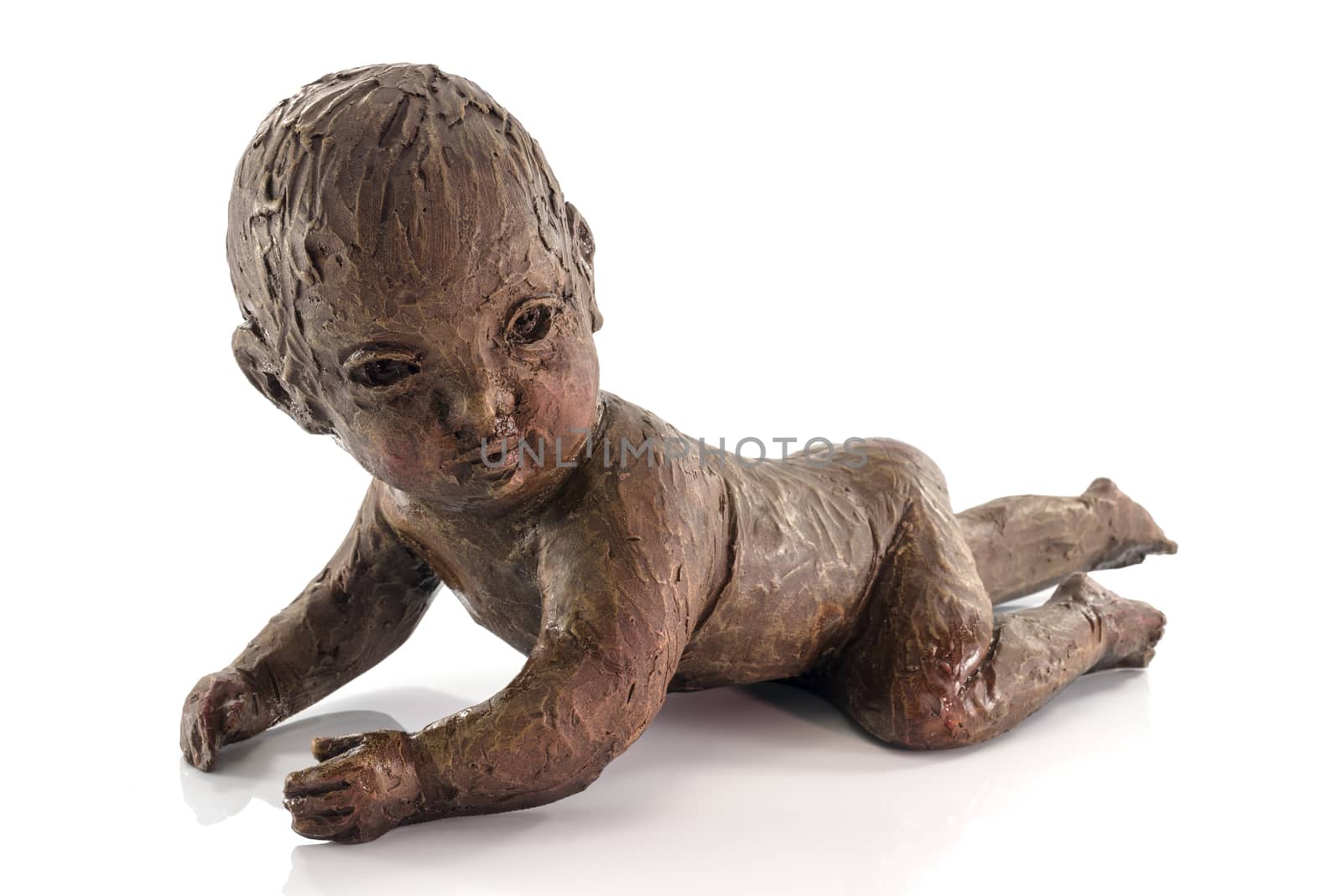 statue of crawlng baby made from clay isolated on white