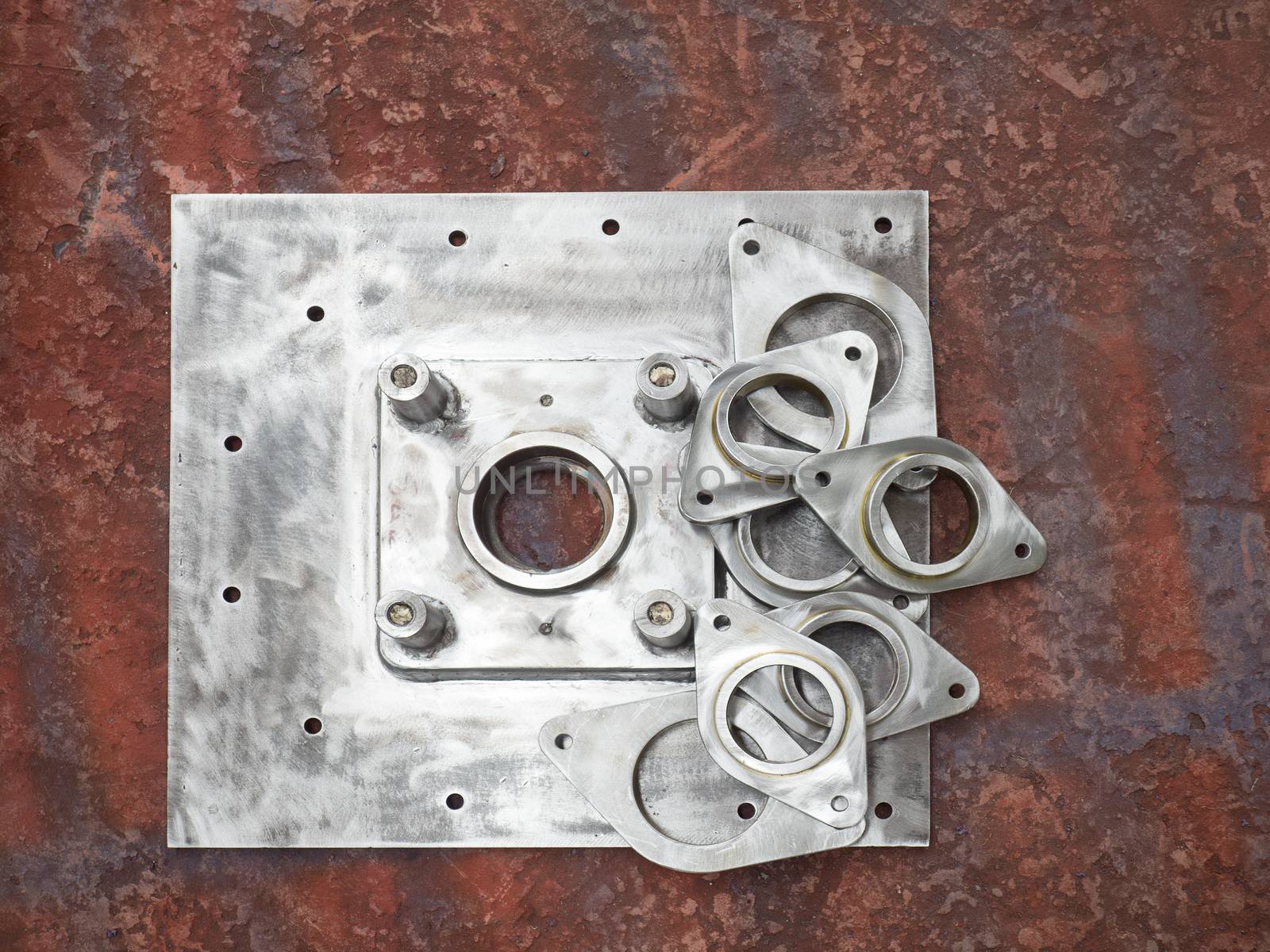 Unpainted steel parts on the workshop floor at a factory