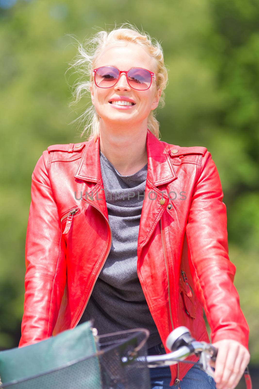 Happy young woman riding a bicycle. in the park.