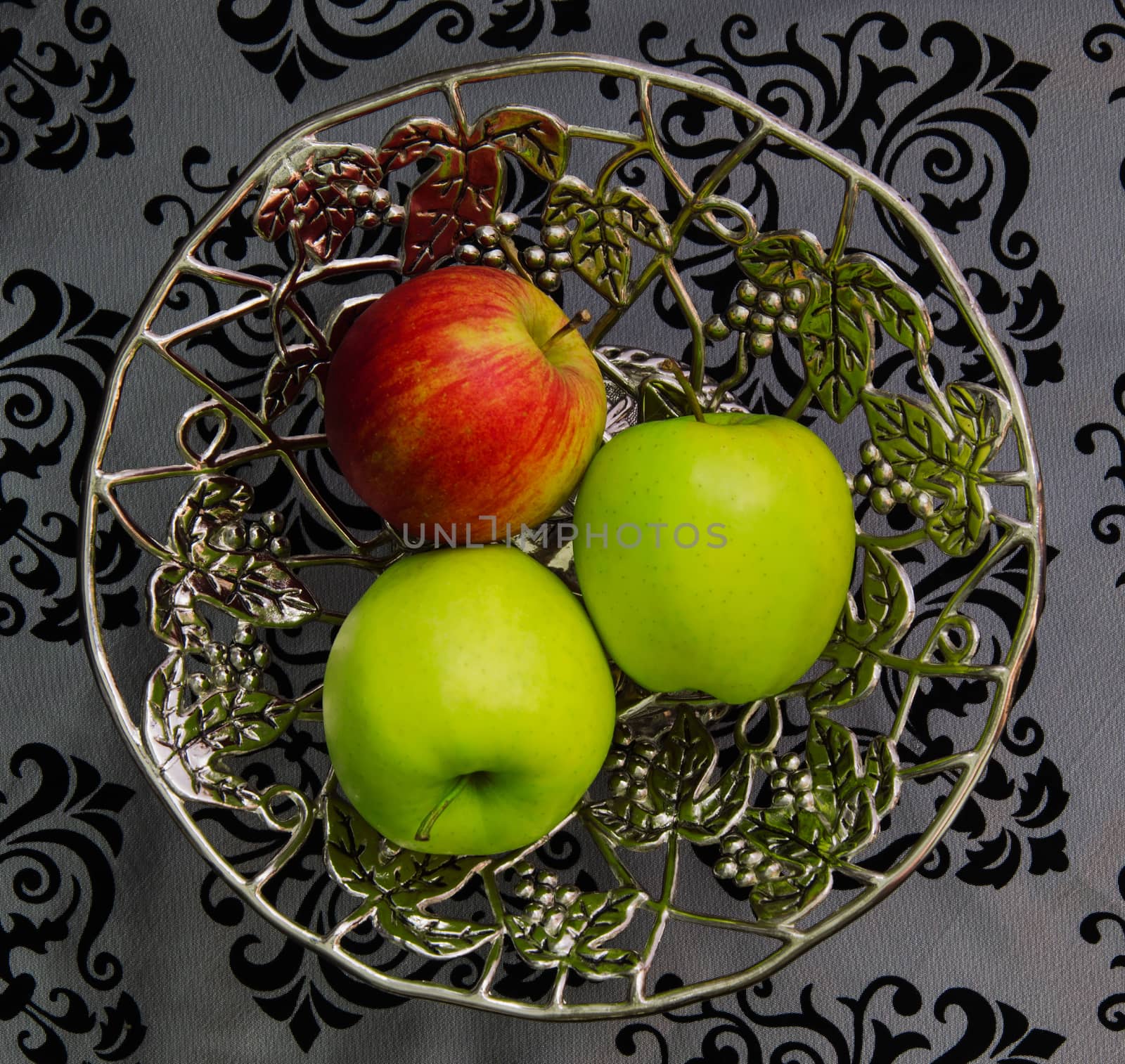 Three apples on a silver platter