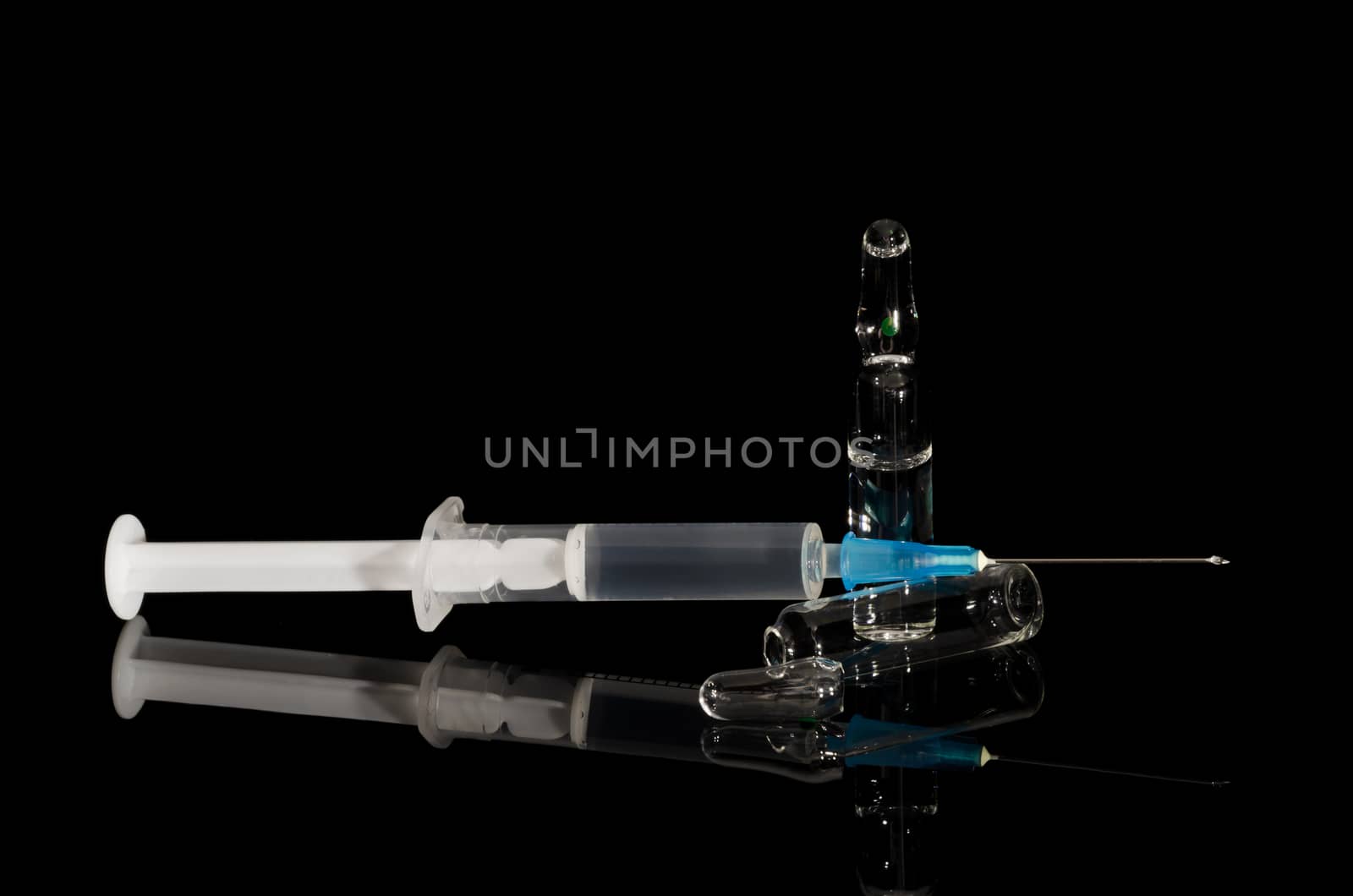 ampoule and syringe on black background