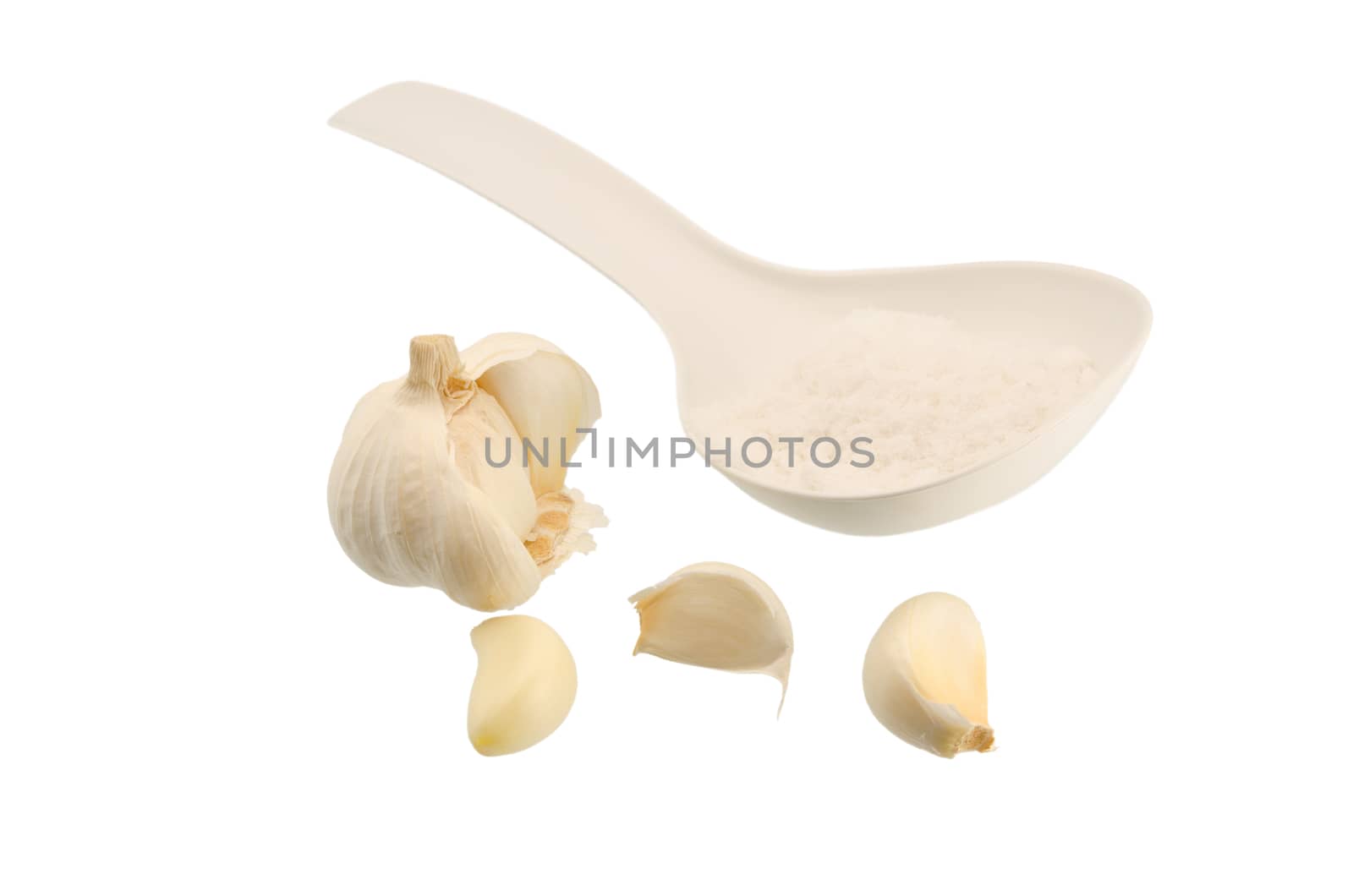 Garlic salt and spoon on a white background