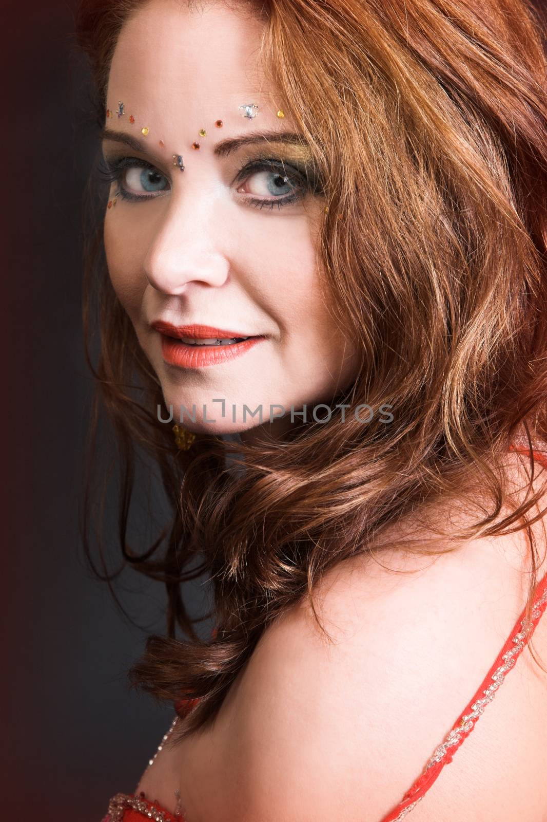 Belly Dancer wearing a red costume with jewelery