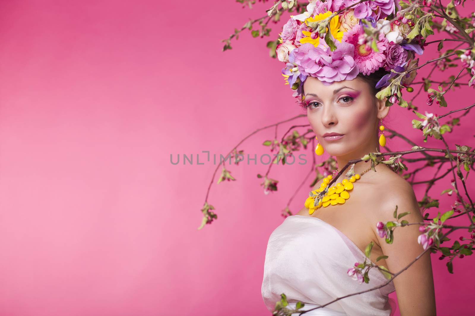 Fashion girl with flower hairstyle and pink background concept
