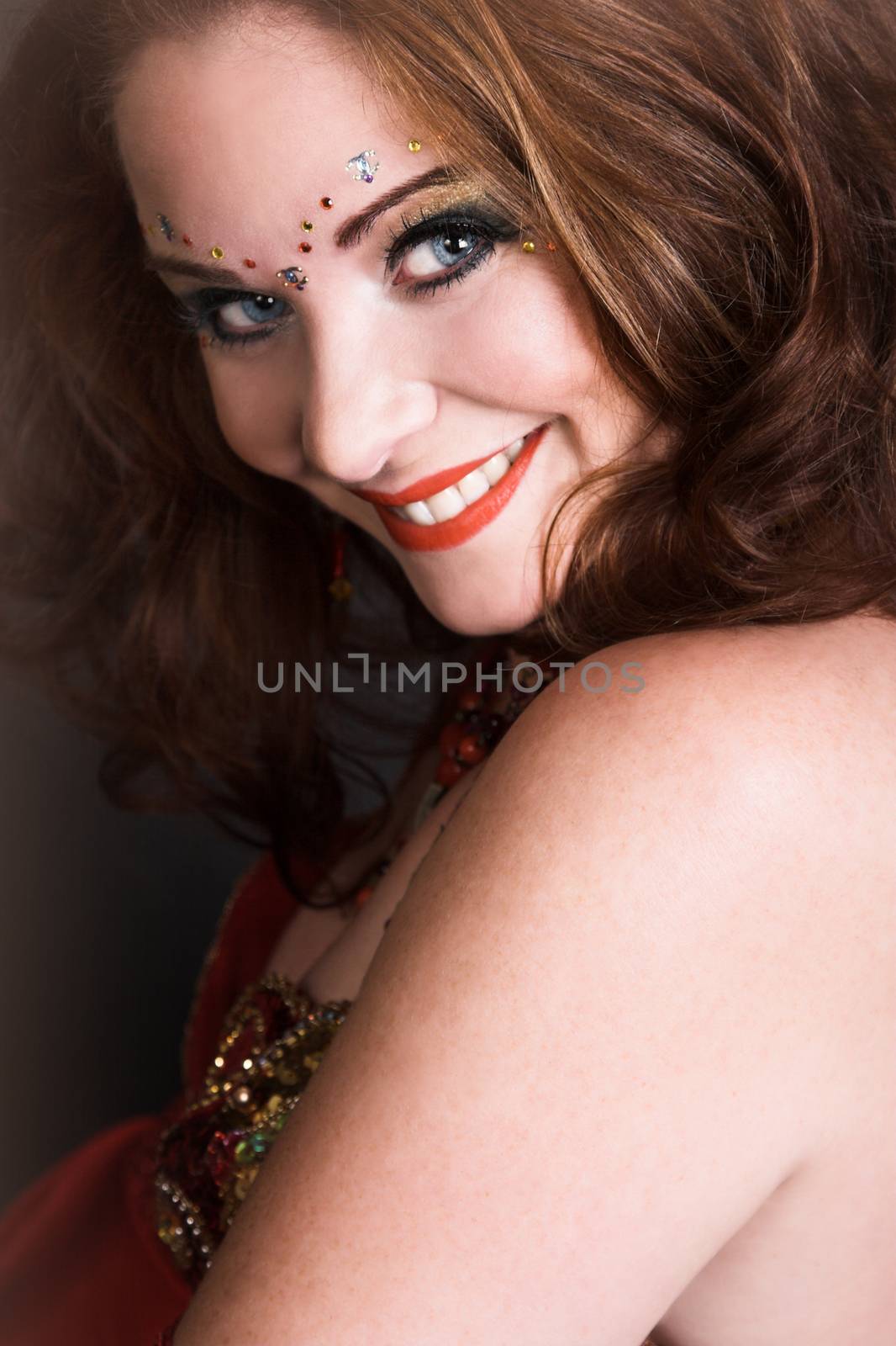 Belly Dancer wearing a red costume with jewelery