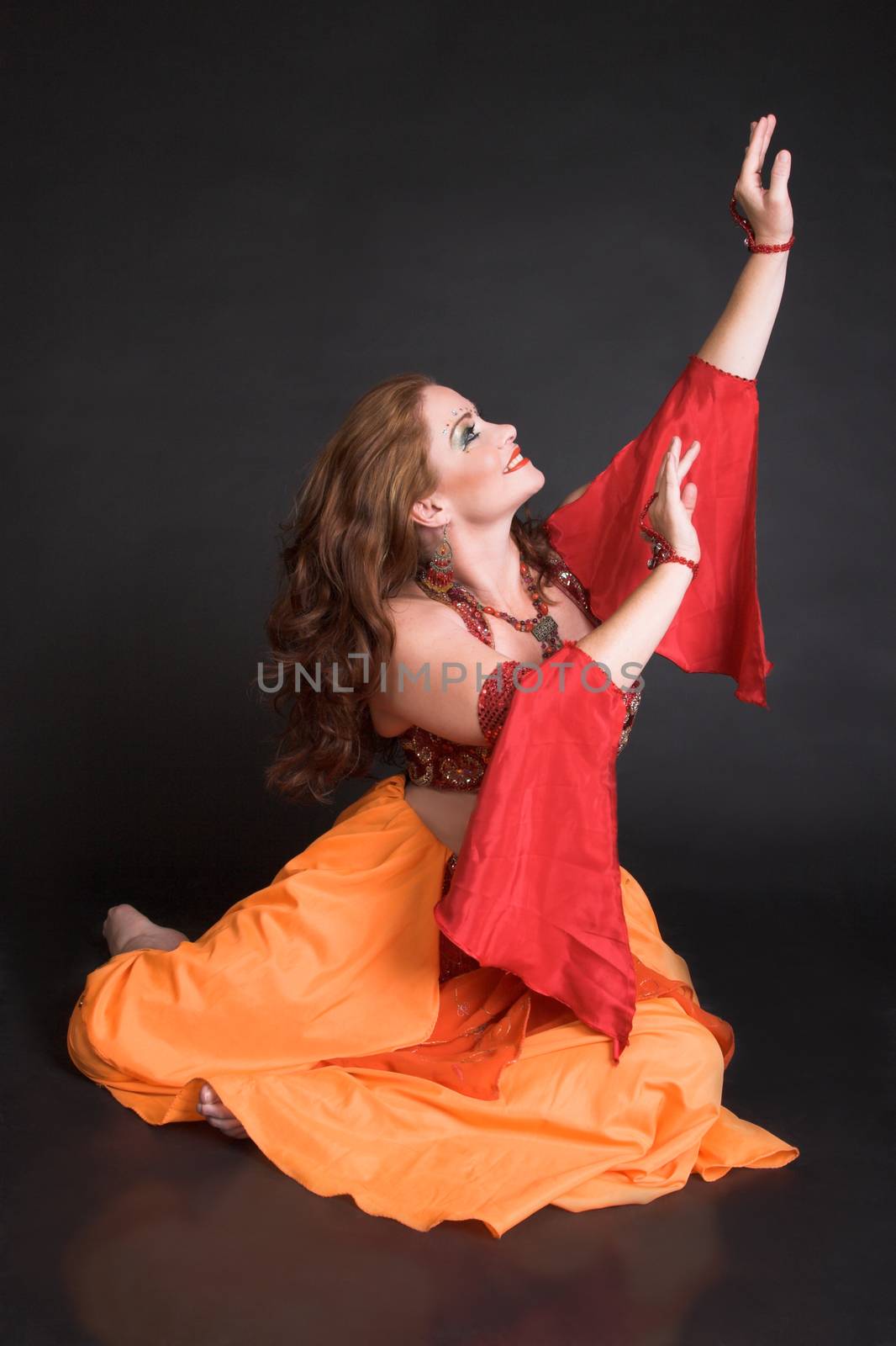 Belly Dancer wearing a red costume with jewelery