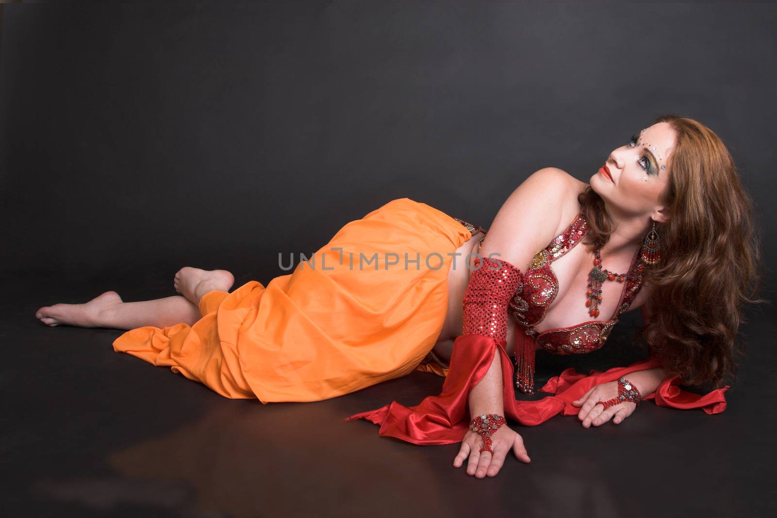 Belly Dancer wearing a red costume with jewelery