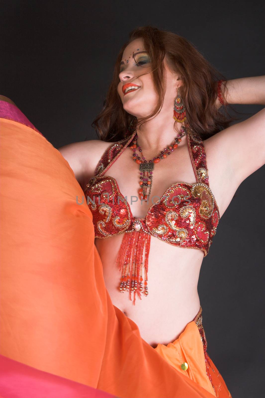 Belly Dancer wearing a red costume with jewelery