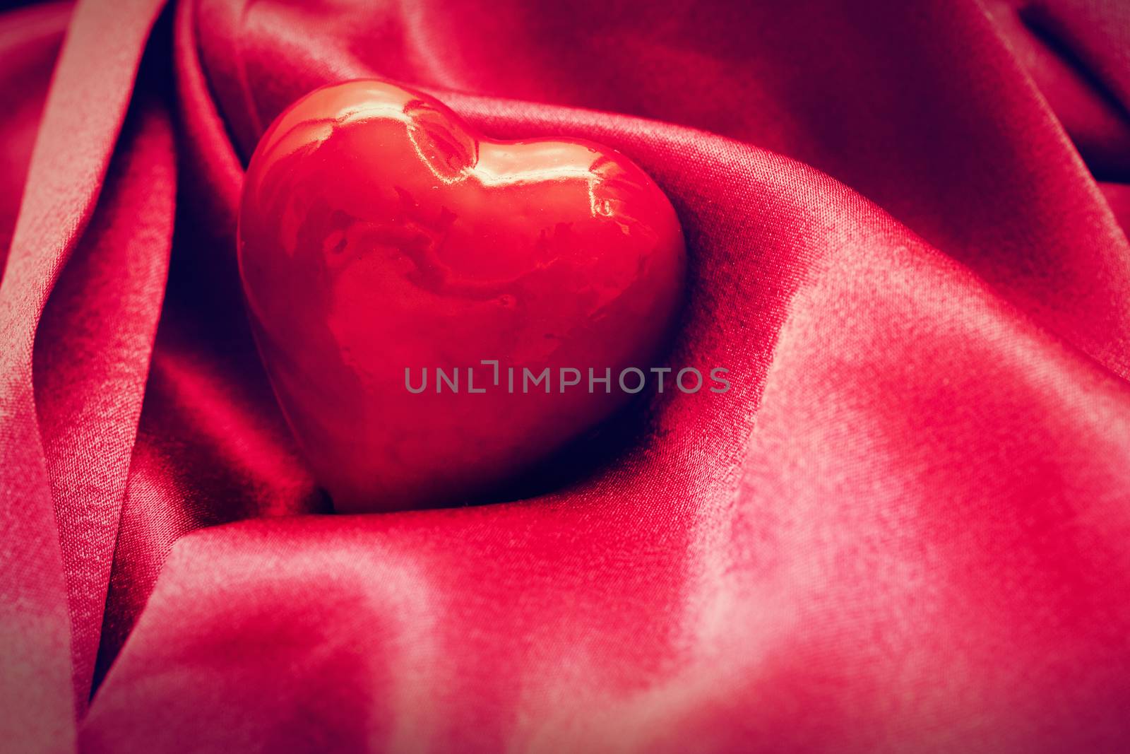 Red heart in satin cloth. Symbol of love, Valentine's Day background
