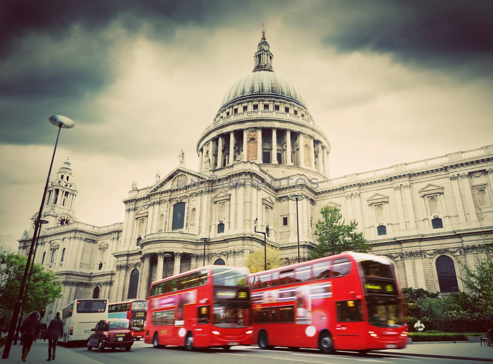 St Paul's Cathedral in London, the UK. Red buses in motion, vintage, retro style