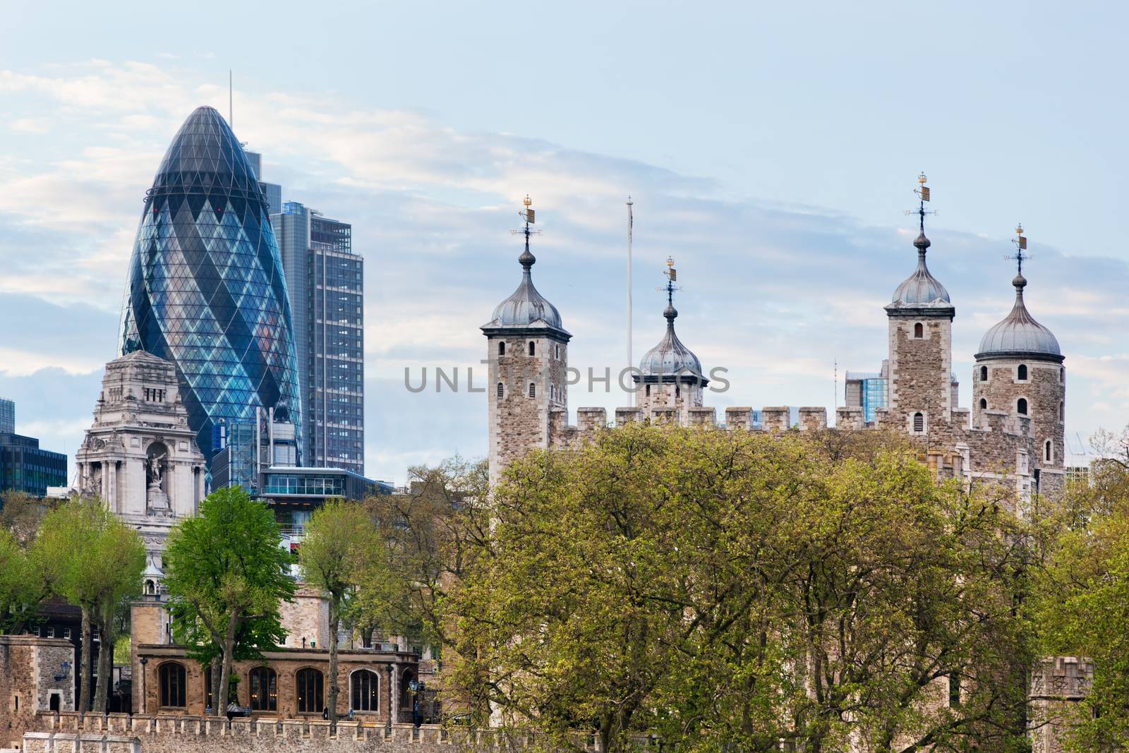 The Tower of London and the 30 St Mary Axe skyscraper aka the Gherkin, England, the UK. The historic Royal Palace and Fortress next to the financial district