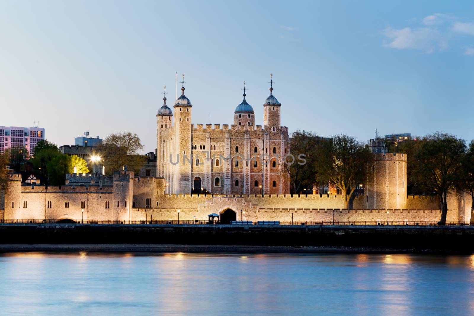 The Tower of London, England, the UK. The historic Royal Palace and Fortress next to the River Thames. Lights at the evening