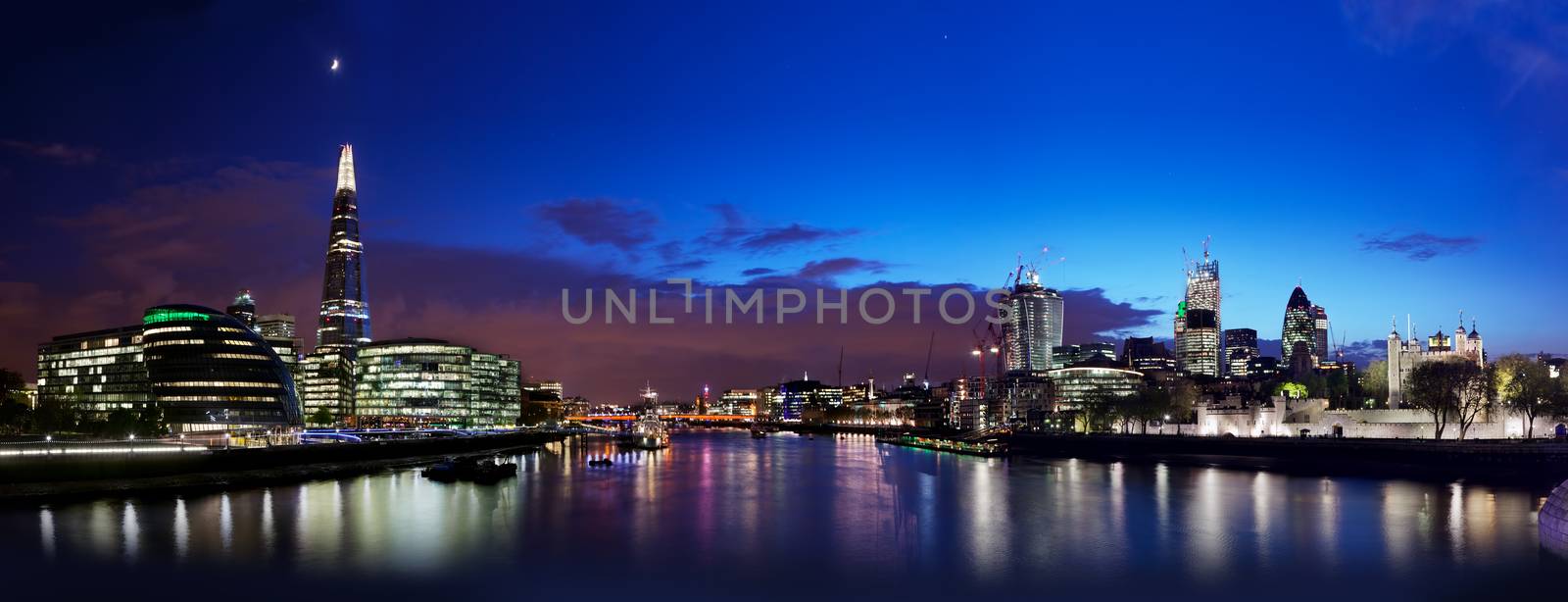 London skyline panorama at night, England the UK. Tower of London, The Shard, City Hall, River Thames as seen from Tower Bridge