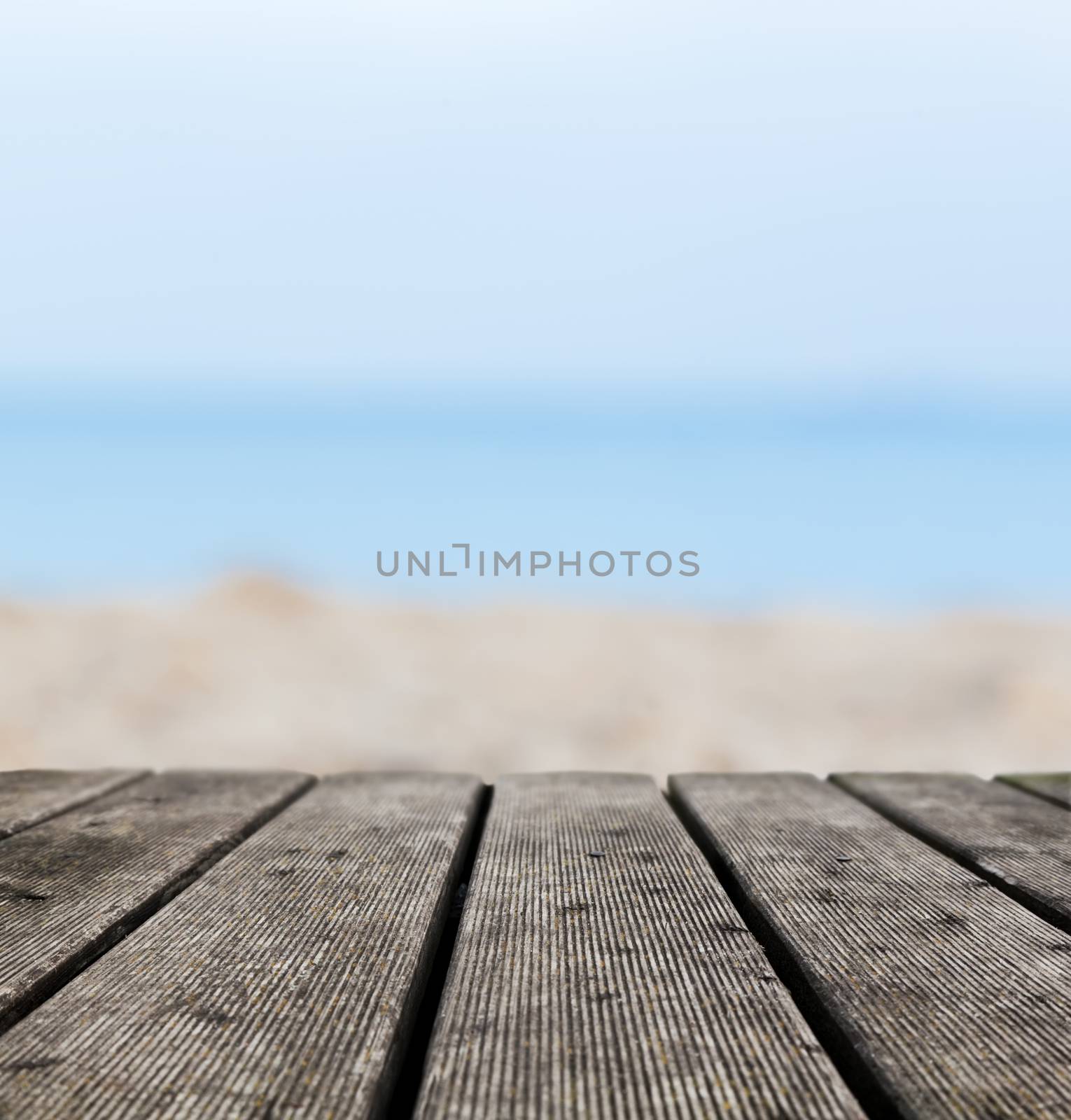Grunge rustic real wood boards on the beach shore, ocean background. Place for an object.