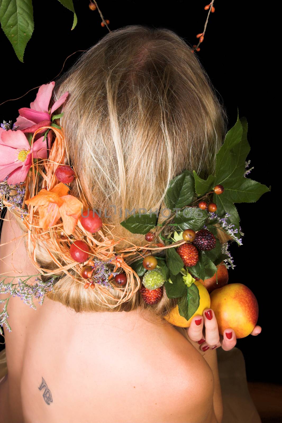 Beautiful young blond model with flowers in her hair