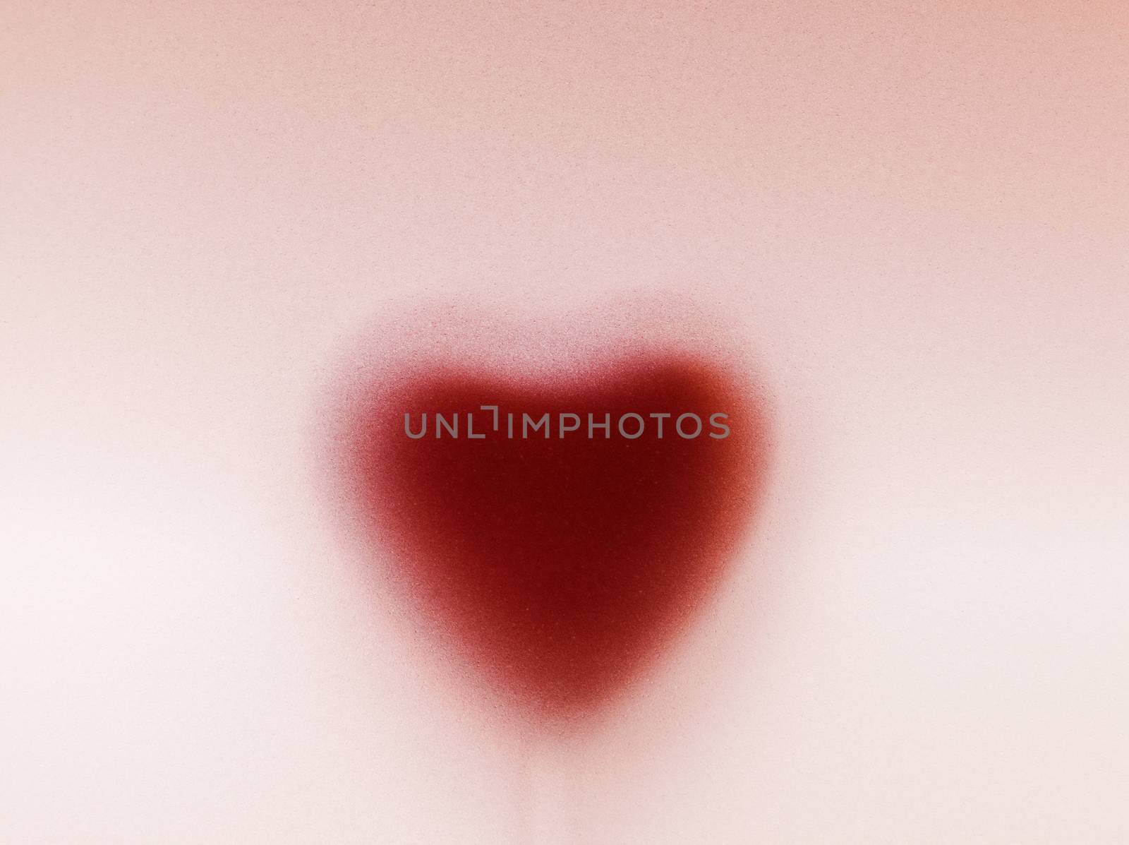 Heart shape behind milky frosted glass. Love, romantic background. Vintage passion for Valentine's Day.
