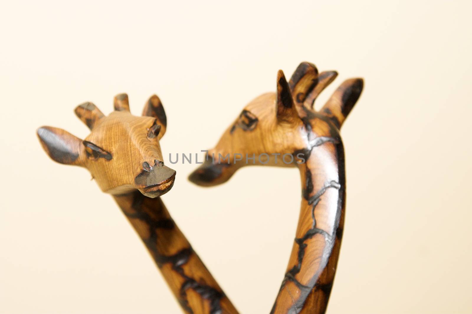 A wooden giraffe figurine and its reflection