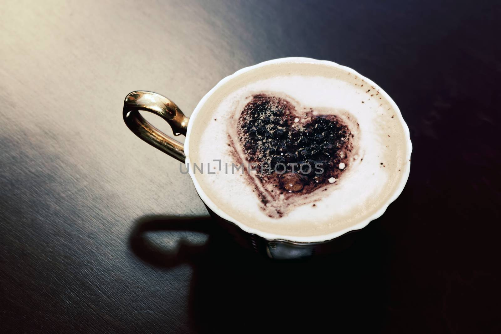 Cup of coffee with chocolate heart shape on milk foam. by photocreo