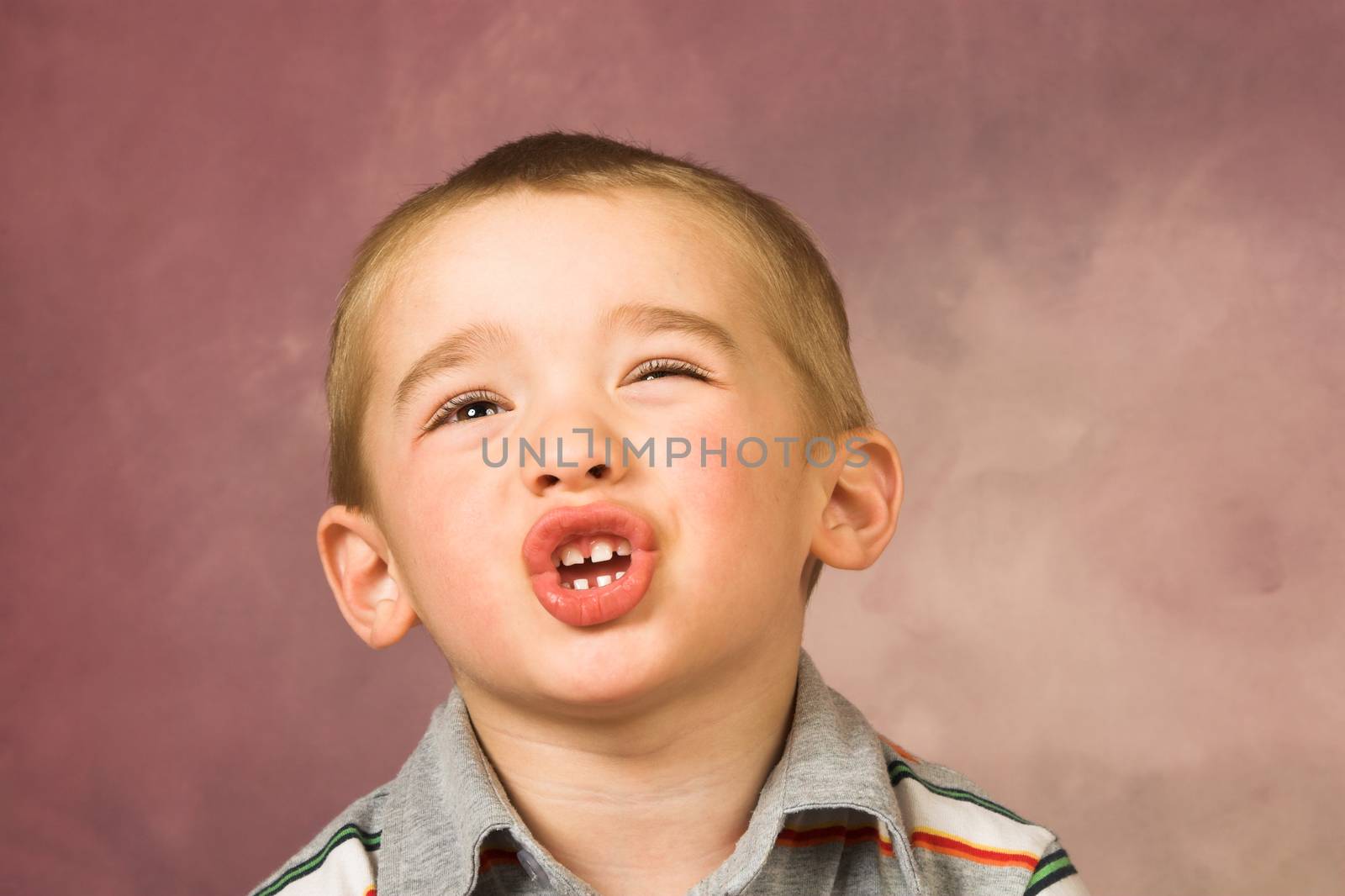 Young boy with short hair and beautiful facial expressions