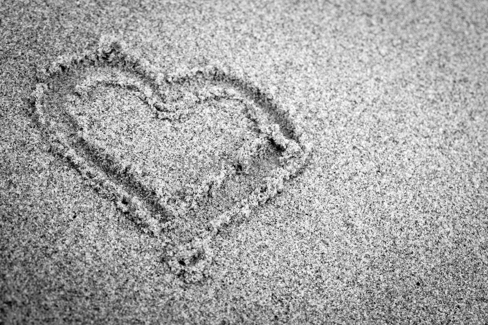 Heart shape on sand. Romantic, black and white, hand drawn.