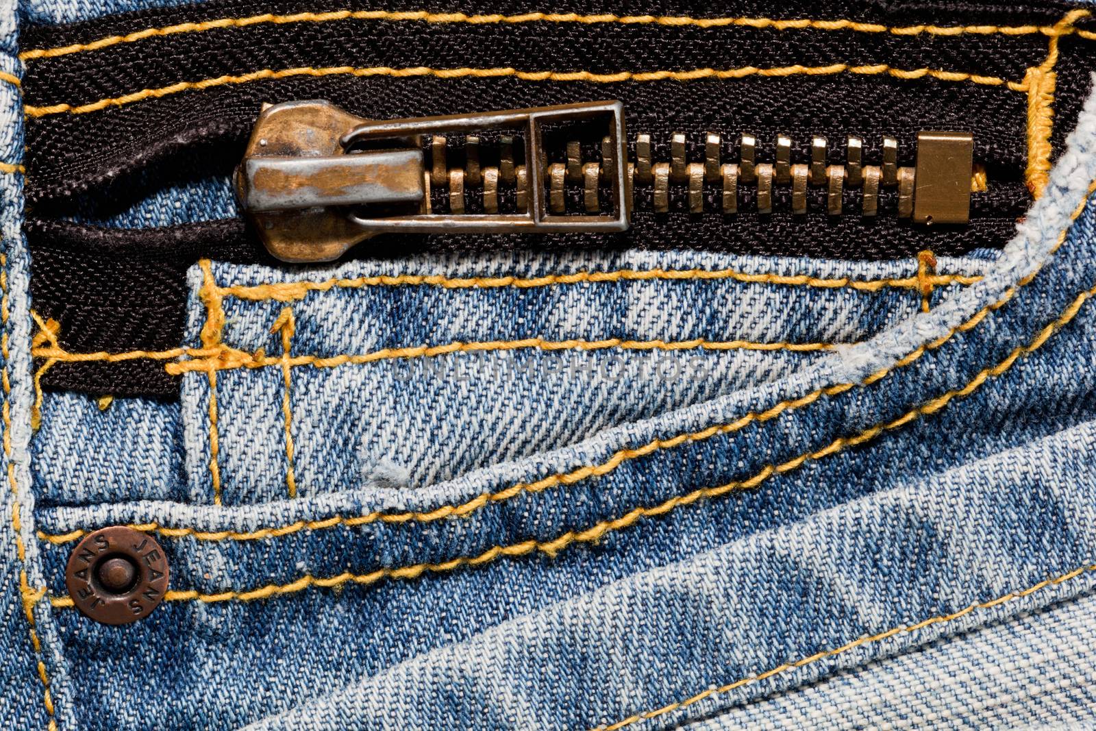 Blue jeans close up on a pocket and a zipper.  by photocreo