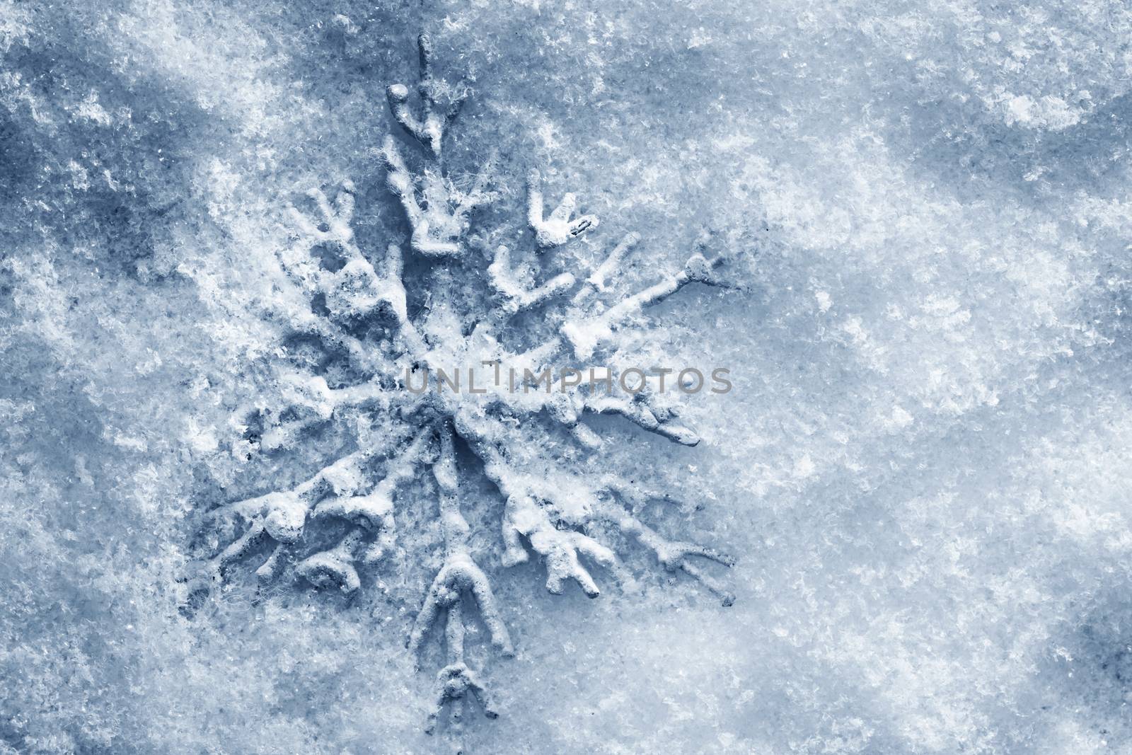Winter, Christmas minimal elegant background. Snowflake on snow, blue tint.