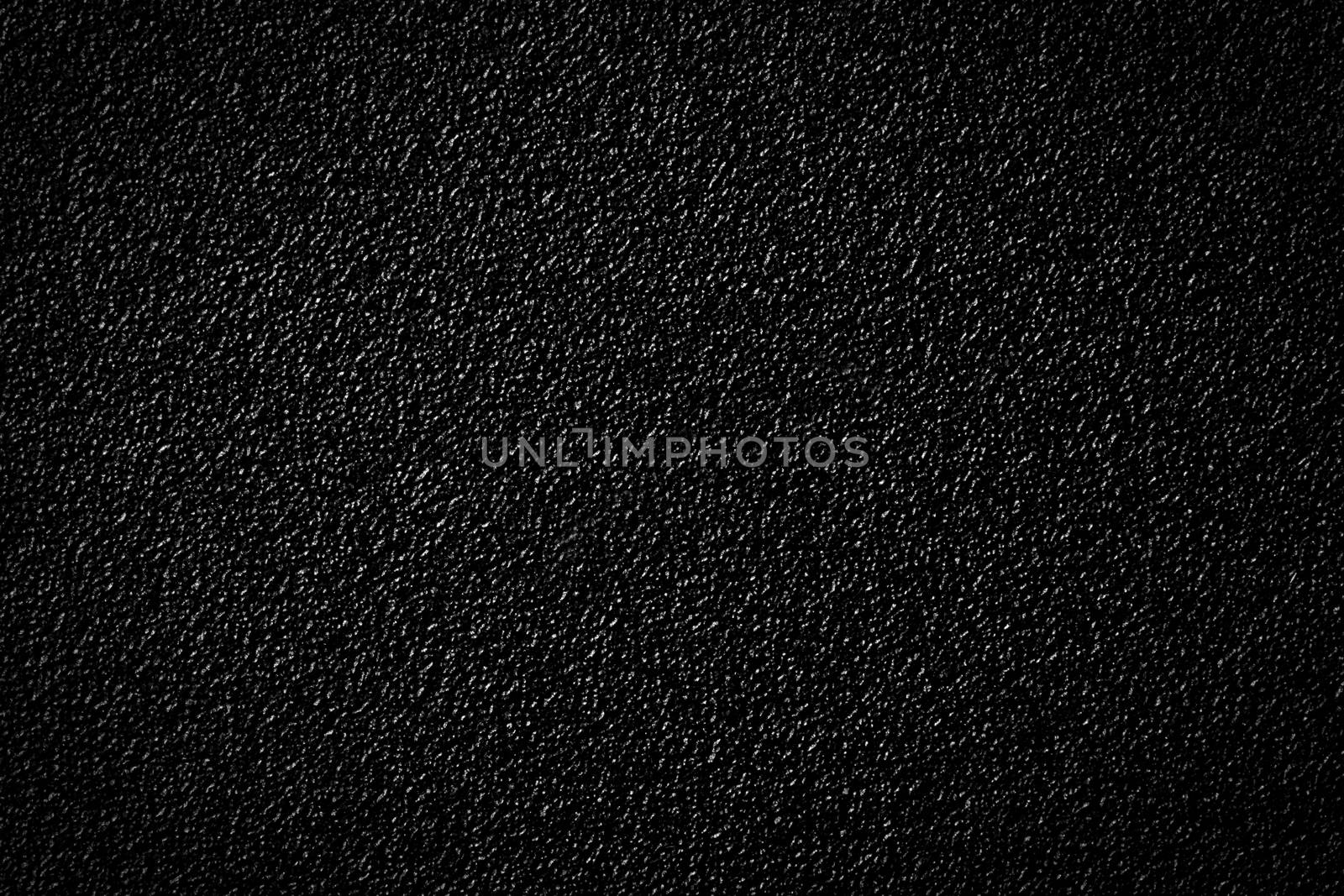 Black plastic background. Close up by photocreo