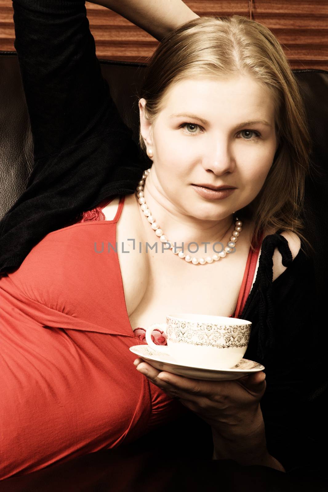 Beautiful young woman enjoying a cup of tea