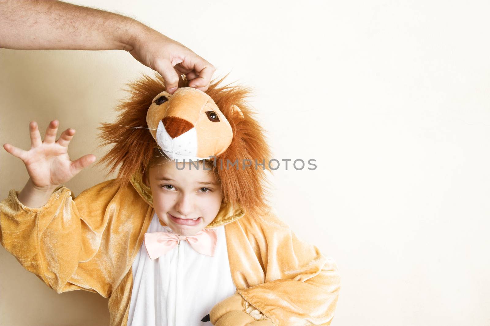 Playful young boy wearing a lion costume