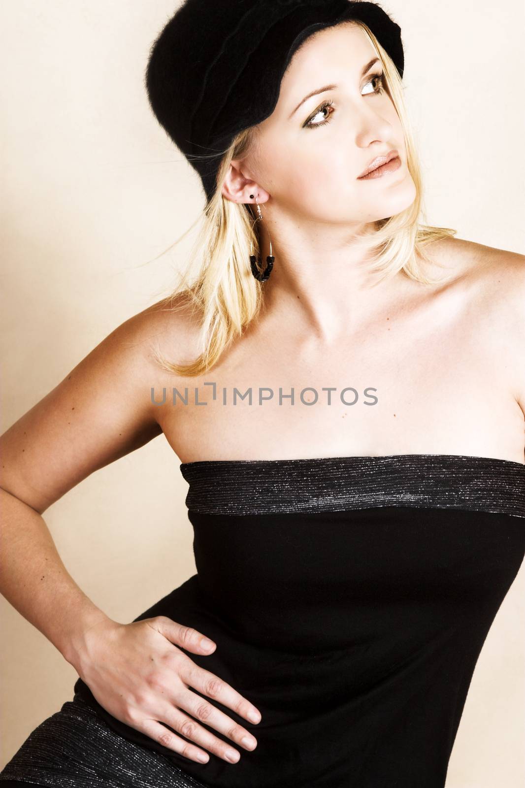 Beautiful young blond model wearing a black hat