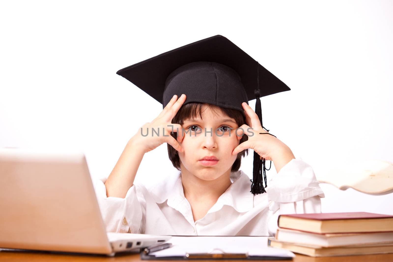 little boy in hat with computer and textbooks on white background