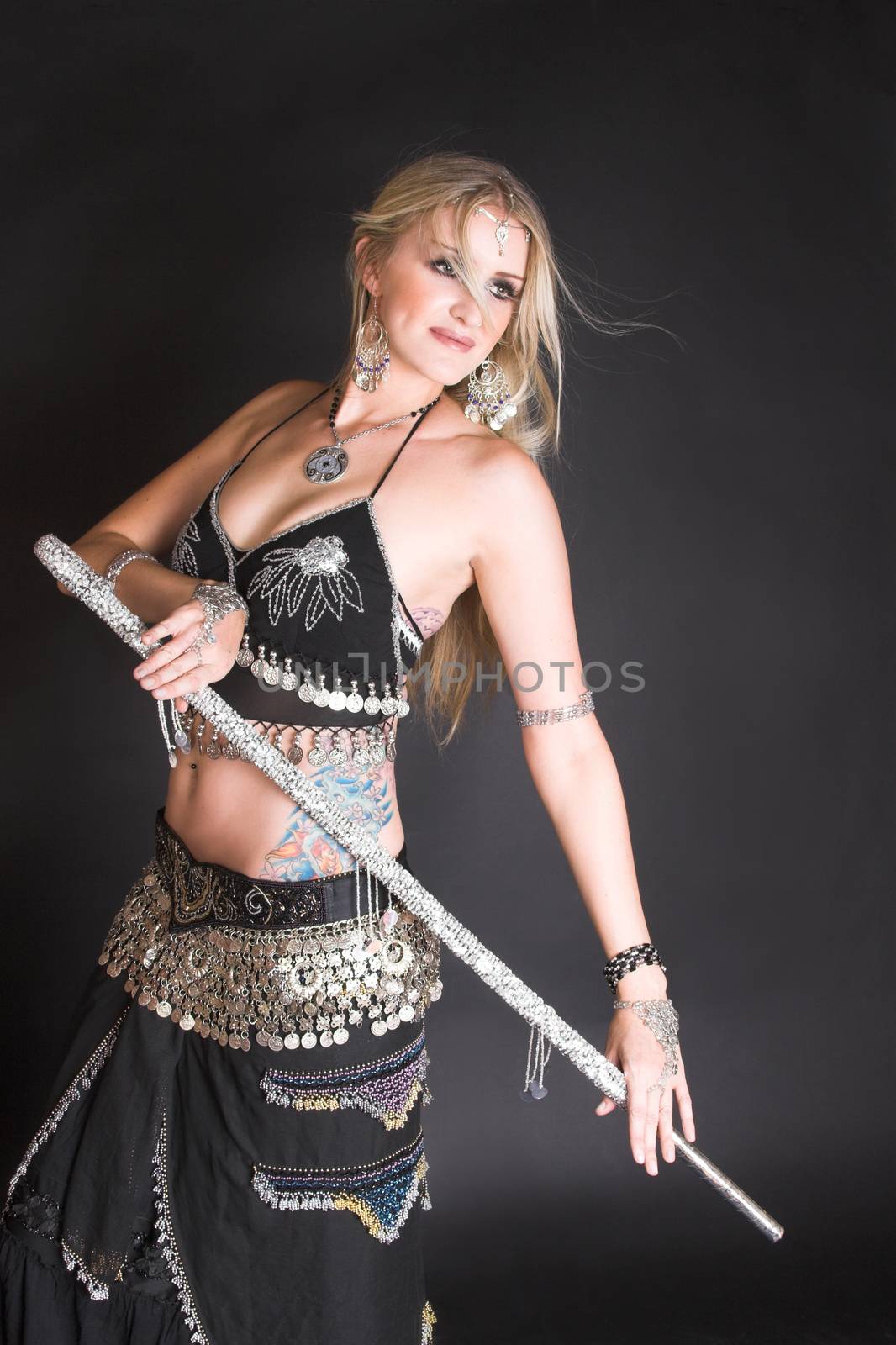 Belly Dancer hands holding a silver decorated tribal cane