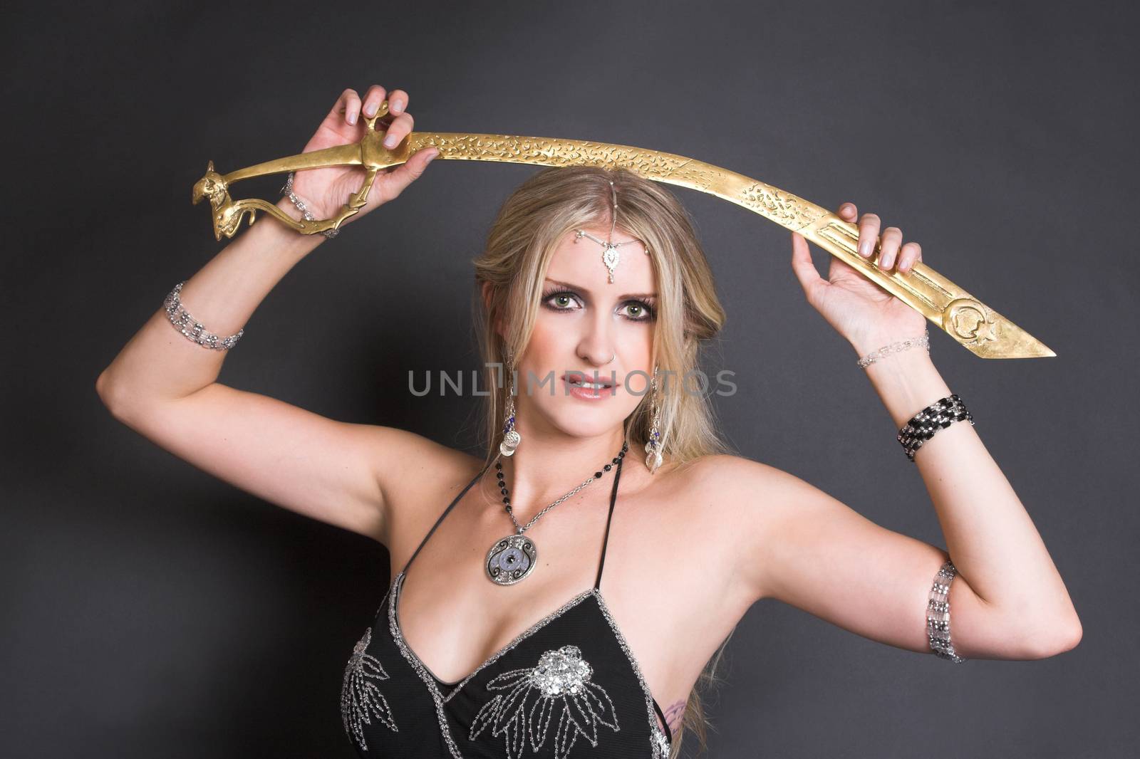 Belly Dancer holding a bronze tribal sword 