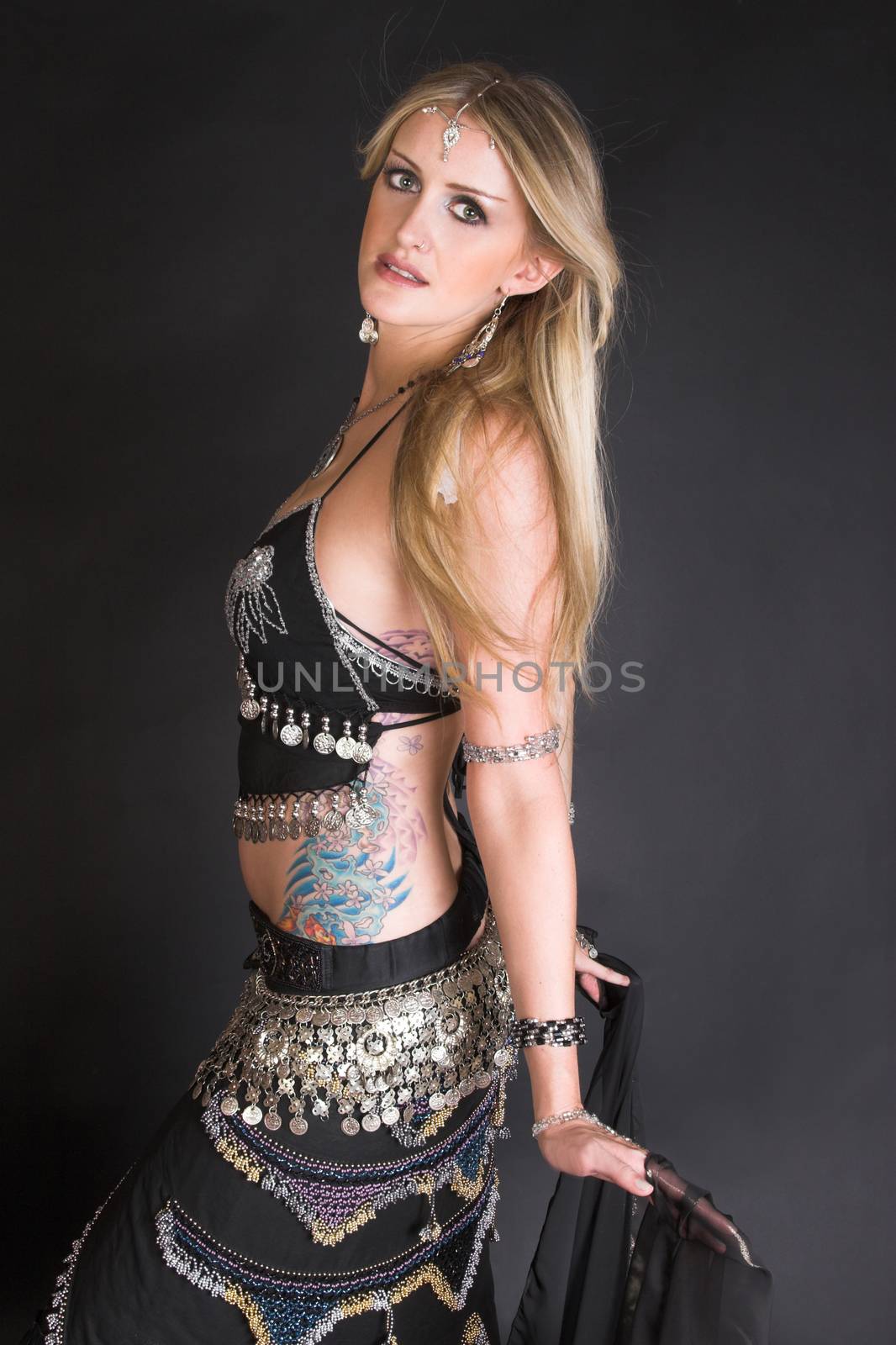 Blond Belly Dancer with long hair holding a scarf