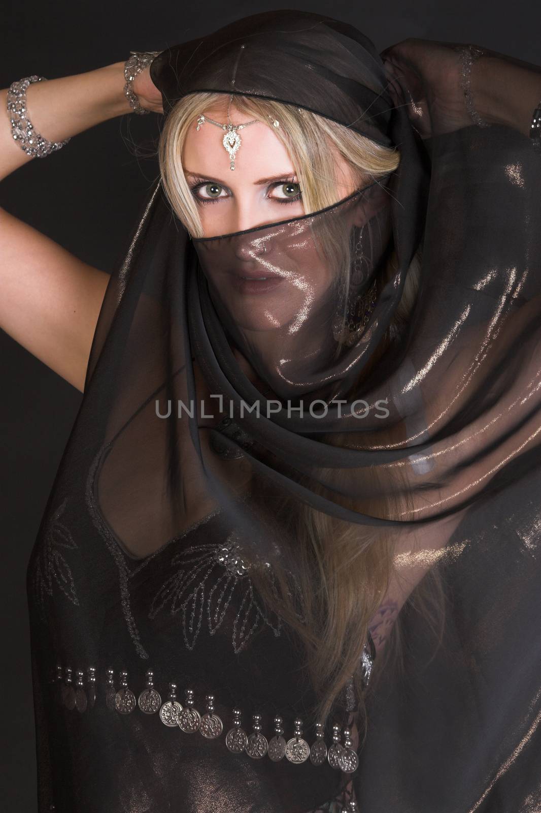 Blond Belly Dancer with long hair holding a scarf